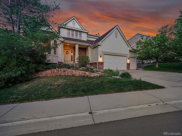 848 Huntington Pl, Highlands Ranch, CO 80126 - view of front facade with an attached garage, a lawn, driveway, and brick siding