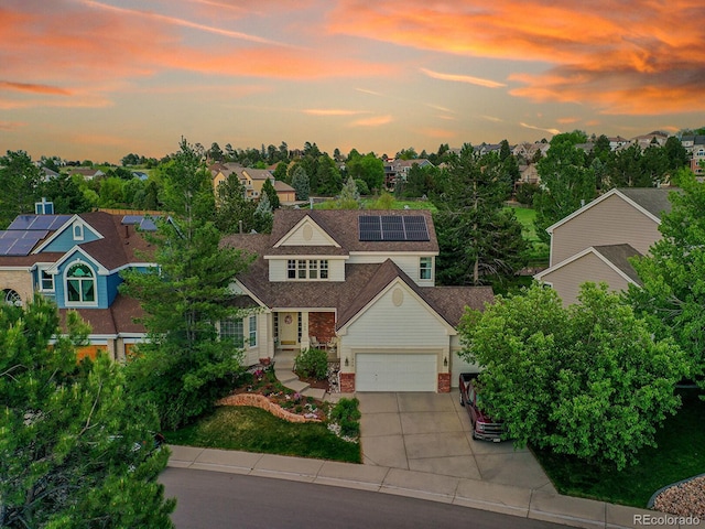 848 Huntington Pl, Highlands Ranch, CO 80126 - view of front of home with concrete driveway, solar panels, and a shingled roof