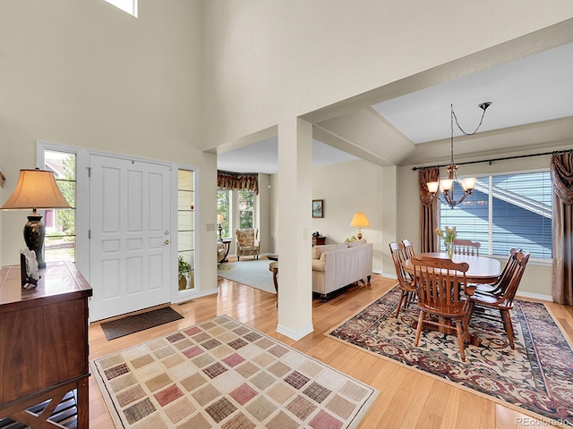 848 Huntington Pl, Highlands Ranch, CO 80126 - foyer with a chandelier, light wood-style flooring, a high ceiling, and baseboards