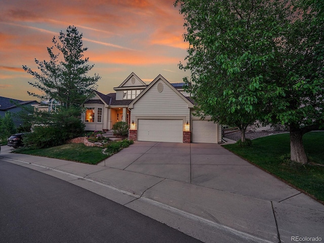 848 Huntington Pl, Highlands Ranch, CO 80126 - view of front facade featuring a garage, brick siding, driveway, and a front yard
