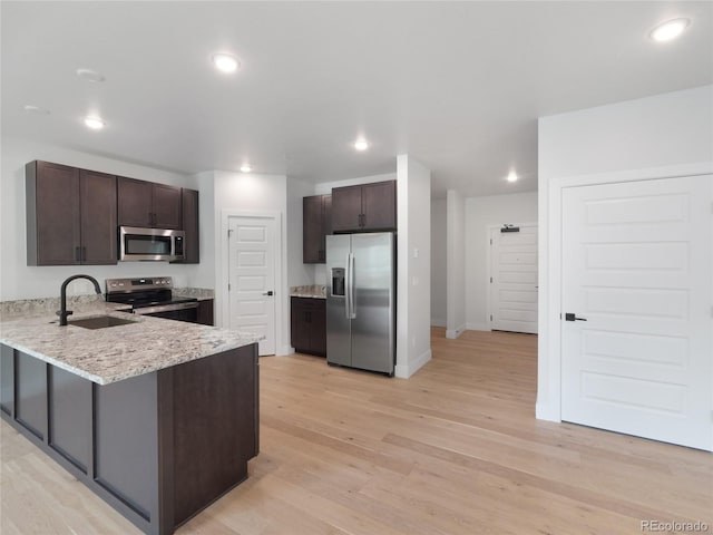 0125 W Keystone Rd Unit 209, Keystone, CO 80435 - kitchen featuring stainless steel appliances, a sink, a peninsula, dark brown cabinets, and recessed lighting