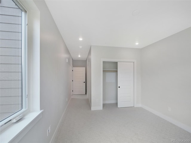 0125 W Keystone Rd Unit 209, Keystone, CO 80435 - unfurnished bedroom with light carpet, recessed lighting, baseboards, and a closet