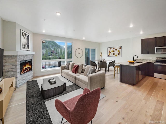 0125 W Keystone Rd Unit 209, Keystone, CO 80435 - living area with light wood finished floors, recessed lighting, and a stone fireplace
