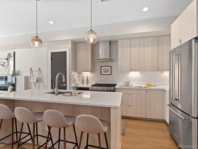 4917 Lowell Blvd Unit 105, Denver, CO 80221 - kitchen with high end refrigerator, modern cabinets, light brown cabinetry, wall chimney exhaust hood, and a sink