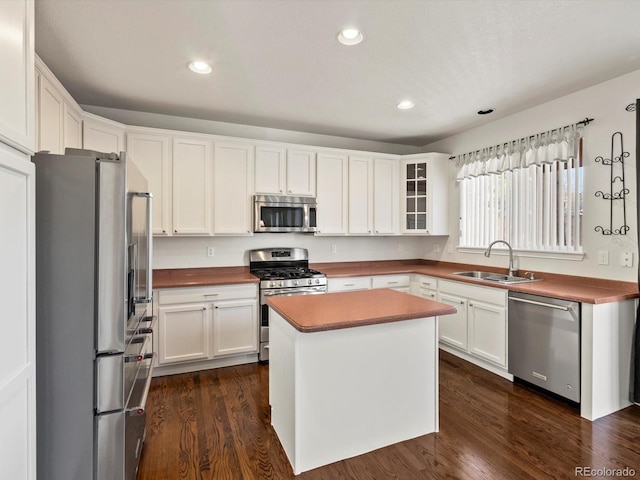 kitchen featuring dark wood-style flooring, recessed lighting, white cabinets, stainless steel appliances, and a sink