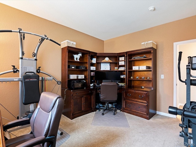 carpeted office space featuring baseboards