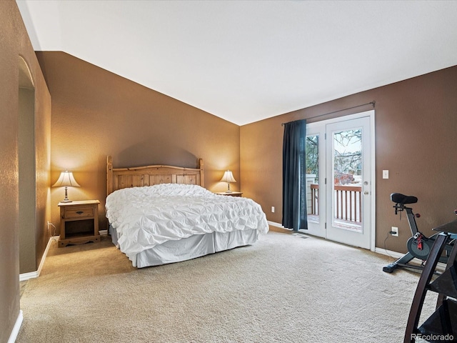 carpeted bedroom featuring access to outside, baseboards, and lofted ceiling