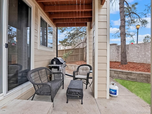 view of patio featuring a grill and a fenced backyard