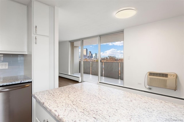 kitchen featuring decorative backsplash, dishwasher, white cabinets, and a wall mounted air conditioner