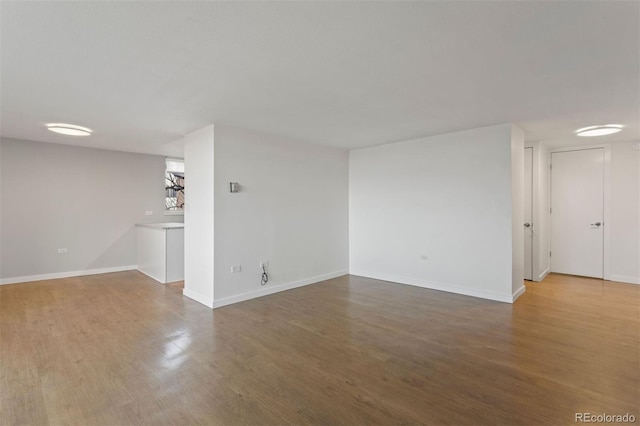 unfurnished room with wood-type flooring