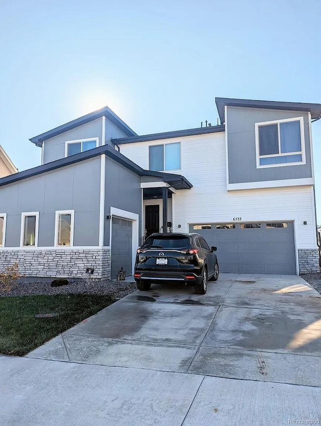 6332 E 142nd Pl, Thornton, CO 80602 - view of front facade with stone siding, concrete driveway, and an attached garage