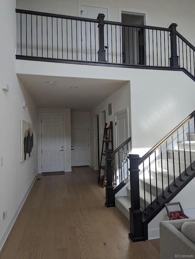 6332 E 142nd Pl, Thornton, CO 80602 - stairs with wood finished floors, baseboards, and a high ceiling