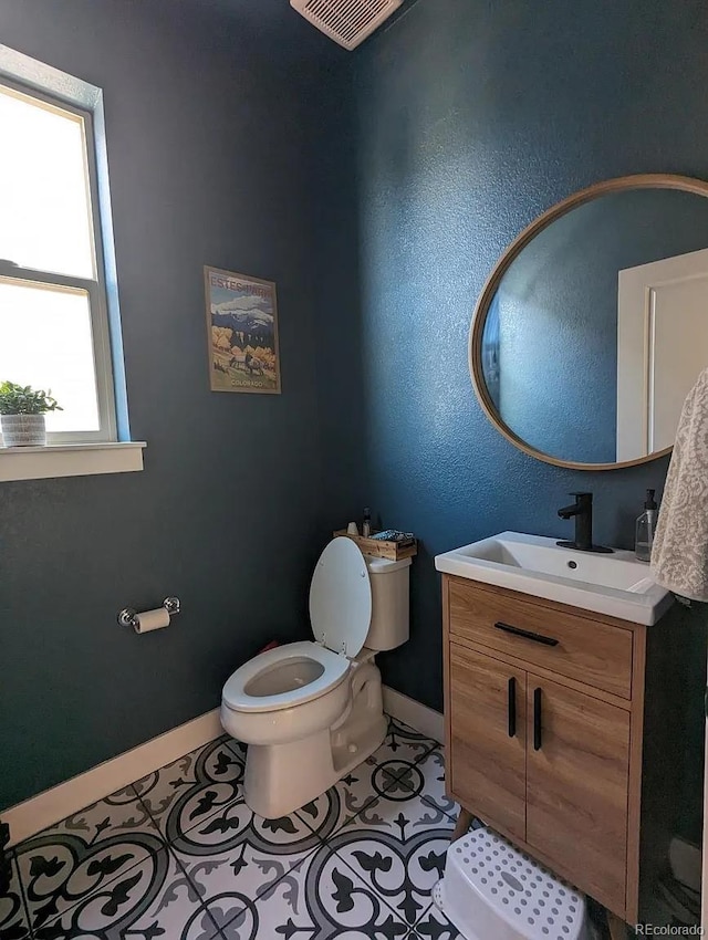 6332 E 142nd Pl, Thornton, CO 80602 - bathroom with toilet, vanity, baseboards, and tile patterned flooring