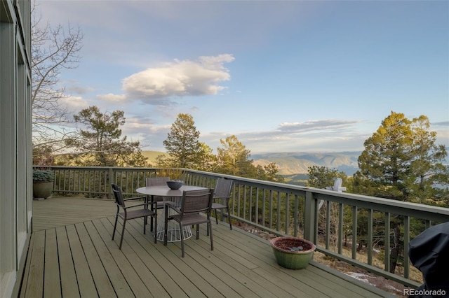 13452 Riley Peak Rd, Conifer, CO 80433 - wooden deck featuring outdoor dining space and a mountain view