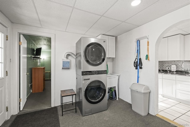 laundry area featuring stacked washing maching and dryer