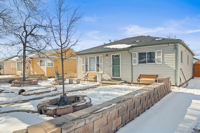 snow covered property featuring a fire pit