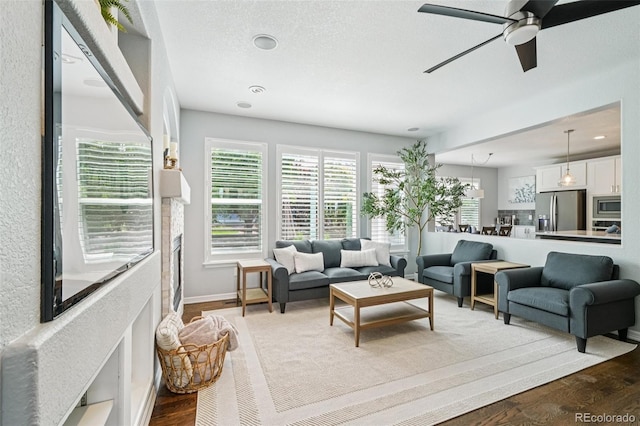 17020 E 107th Ave, Commerce City, CO 80022 - living area with wood finished floors, a ceiling fan, recessed lighting, and a textured ceiling