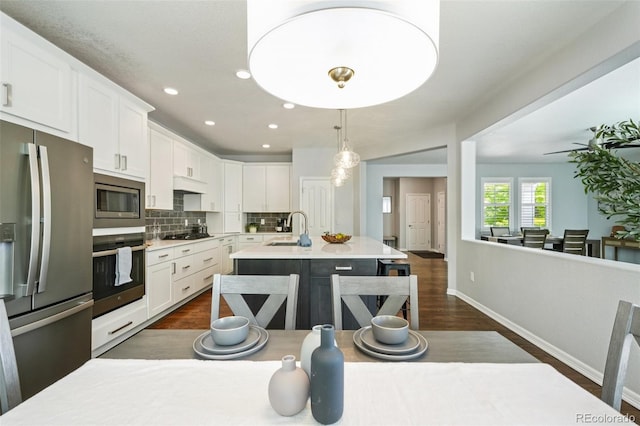 17020 E 107th Ave, Commerce City, CO 80022 - kitchen featuring appliances with stainless steel finishes, dark wood-type flooring, white cabinets, and recessed lighting