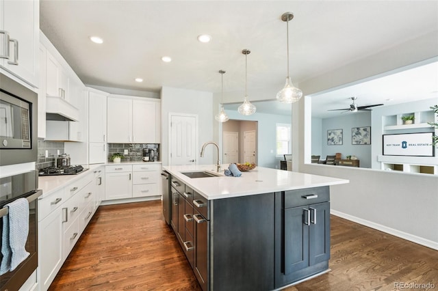 17020 E 107th Ave, Commerce City, CO 80022 - kitchen featuring appliances with stainless steel finishes, white cabinetry, dark wood-style flooring, light countertops, and recessed lighting