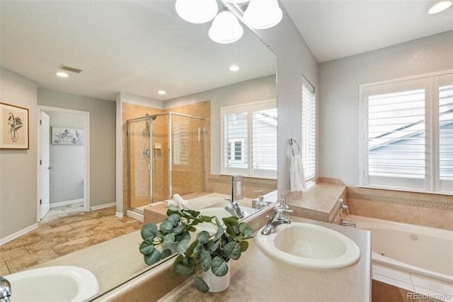 17020 E 107th Ave, Commerce City, CO 80022 - bathroom featuring a garden tub, a stall shower, double vanity, and recessed lighting