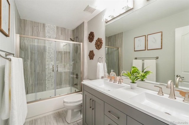 17020 E 107th Ave, Commerce City, CO 80022 - full bath with double vanity, combined bath / shower with glass door, and wood finished floors