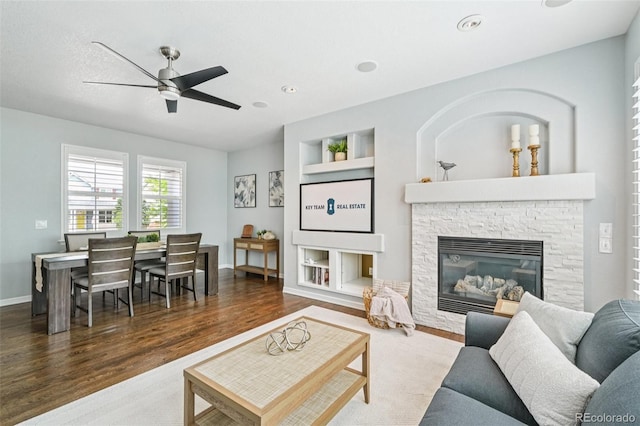 17020 E 107th Ave, Commerce City, CO 80022 - living area with ceiling fan, wood finished floors, built in shelves, a stone fireplace, and recessed lighting