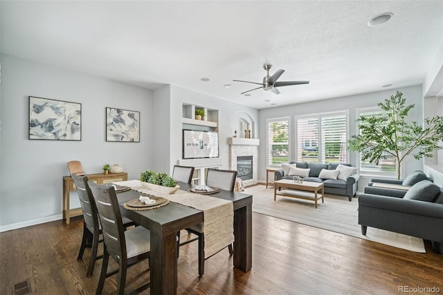 17020 E 107th Ave, Commerce City, CO 80022 - dining area featuring a ceiling fan, a fireplace, dark wood-style floors, and recessed lighting
