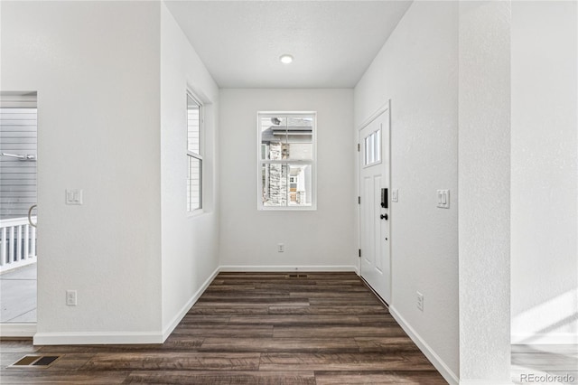 3295 N Coolidge Way, Aurora, CO 80019 - entryway with baseboards and dark wood-type flooring
