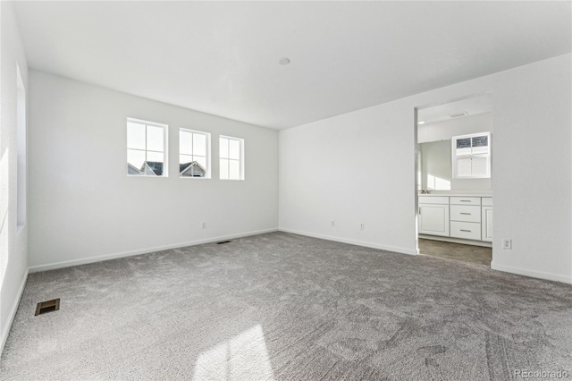 3295 N Coolidge Way, Aurora, CO 80019 - unfurnished room featuring healthy amount of natural light, carpet floors, and baseboards