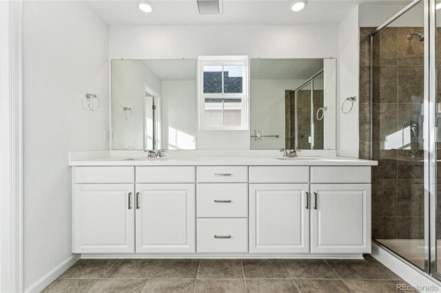 3295 N Coolidge Way, Aurora, CO 80019 - bathroom featuring double vanity, a shower stall, and recessed lighting