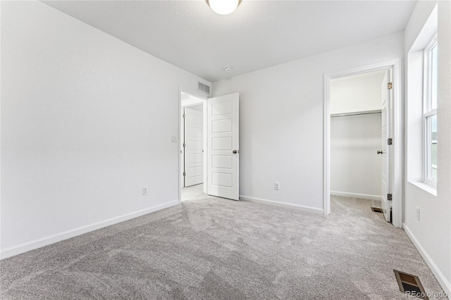 3295 N Coolidge Way, Aurora, CO 80019 - unfurnished bedroom with carpet, baseboards, and a spacious closet