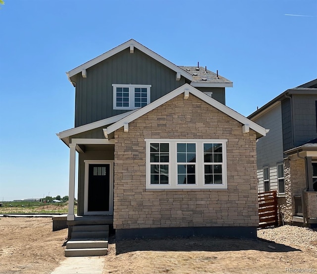 3295 N Coolidge Way, Aurora, CO 80019 - view of front of home with entry steps, stone siding, and board and batten siding