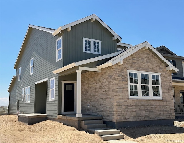 3295 N Coolidge Way, Aurora, CO 80019 - view of front of house with stone siding and board and batten siding