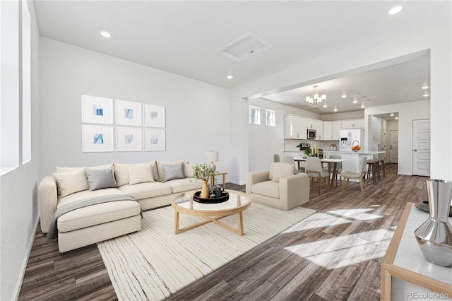 3295 N Coolidge Way, Aurora, CO 80019 - living room with dark wood-style flooring, recessed lighting, a chandelier, and baseboards