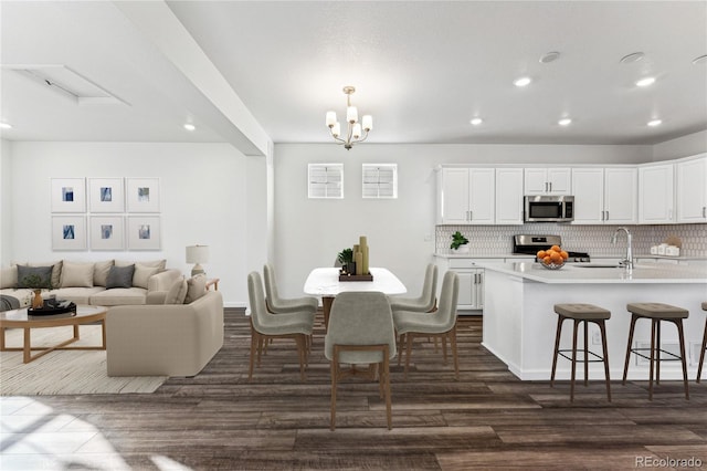 3295 N Coolidge Way, Aurora, CO 80019 - dining area with recessed lighting, dark wood-style flooring, and a chandelier