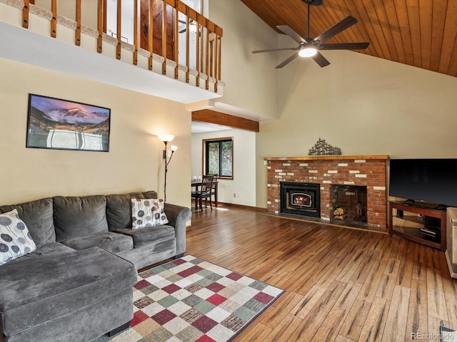 28272 Shadow Mountain Dr, Conifer, CO 80433 - living room with high vaulted ceiling, wood finished floors, wooden ceiling, ceiling fan, and a brick fireplace
