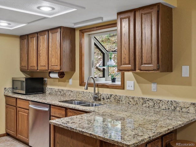 28272 Shadow Mountain Dr, Conifer, CO 80433 - kitchen featuring appliances with stainless steel finishes, a sink, brown cabinets, and light stone counters