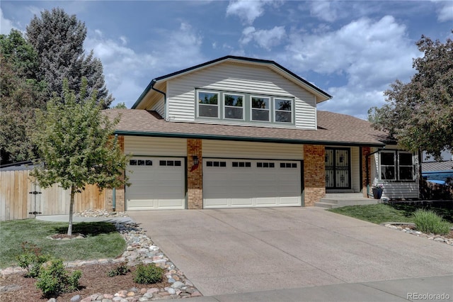 8043 S Zephyr St, Littleton, CO 80128 - view of front of house featuring brick siding, driveway, a shingled roof, and a garage