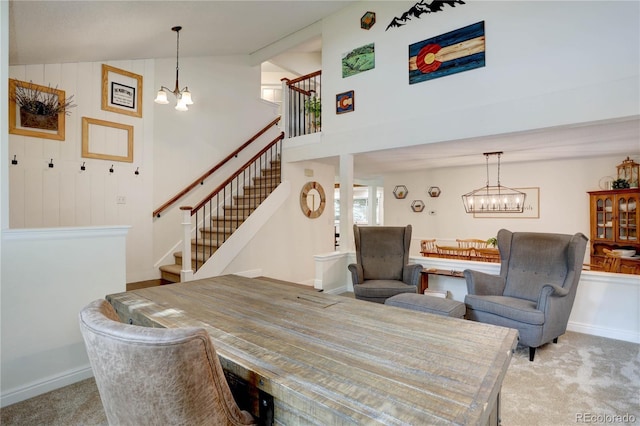 8043 S Zephyr St, Littleton, CO 80128 - dining area with a chandelier, stairs, carpet flooring, and lofted ceiling