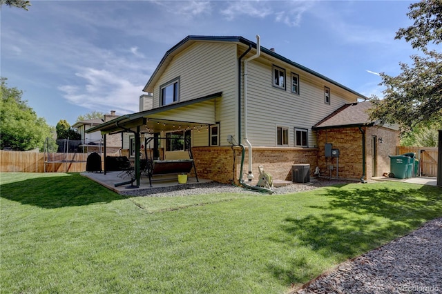 8043 S Zephyr St, Littleton, CO 80128 - back of property featuring a patio and brick siding