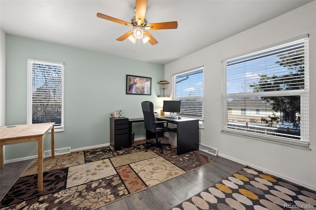 office area with ceiling fan, wood finished floors, visible vents, and baseboards