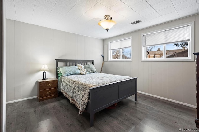 bedroom featuring baseboards, visible vents, and dark wood-style flooring