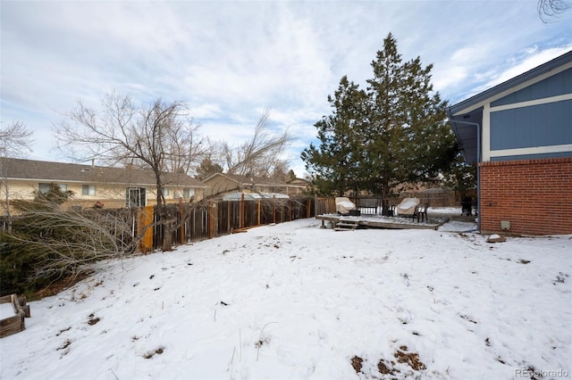 snowy yard with fence