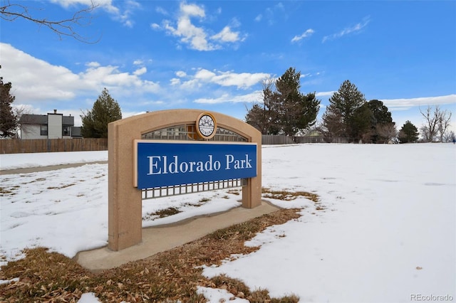 community / neighborhood sign with fence