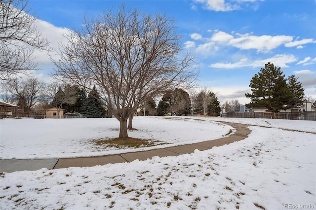 yard covered in snow with fence