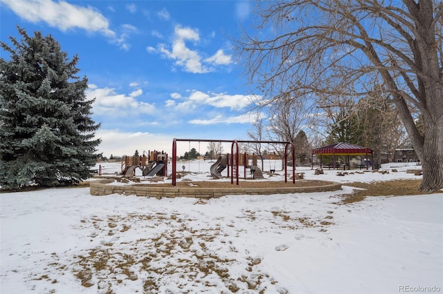 yard layered in snow featuring a playground and a gazebo