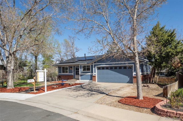 16933 E Bethany Pl, Aurora, CO 80013 - single story home with fence, concrete driveway, an attached garage, solar panels, and brick siding