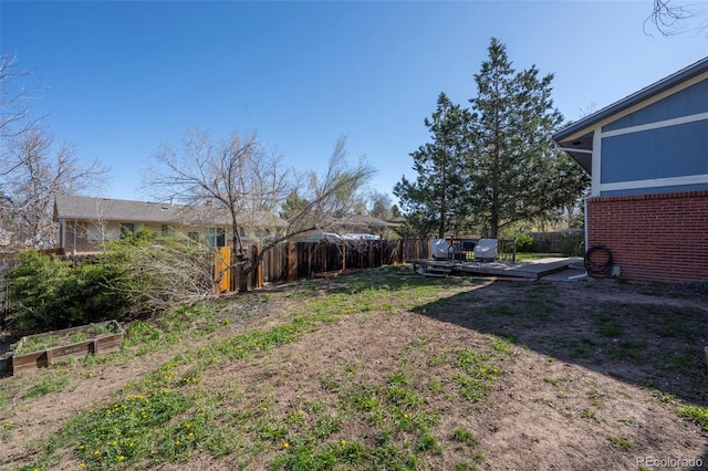 16933 E Bethany Pl, Aurora, CO 80013 - view of yard with a fenced backyard, a garden, and a deck
