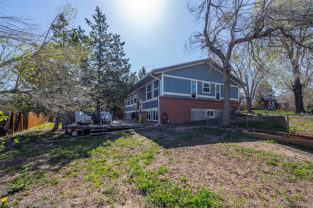 16933 E Bethany Pl, Aurora, CO 80013 - rear view of house featuring brick siding, a wooden deck, and fence