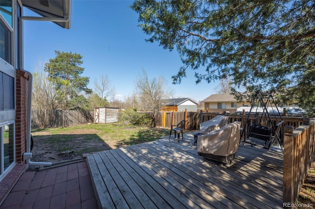 16933 E Bethany Pl, Aurora, CO 80013 - wooden deck featuring an outdoor structure, a storage unit, a fenced backyard, and a yard